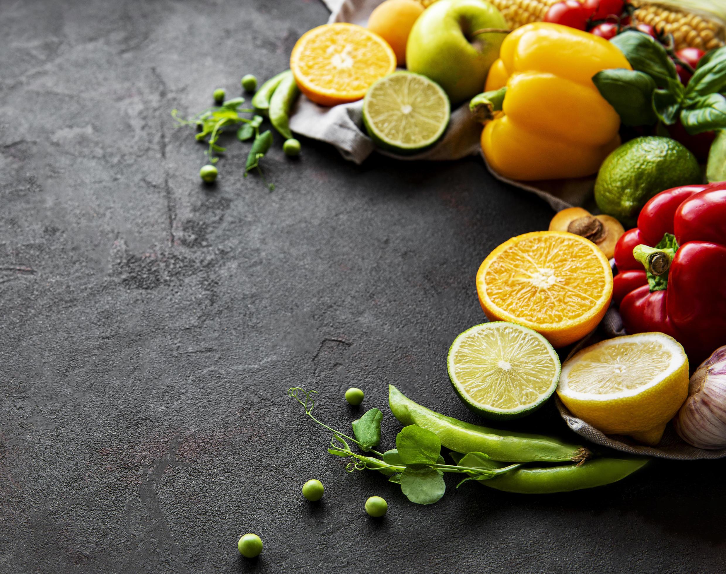 Healthy food. Vegetables and fruits on a black concrete background. Stock Free