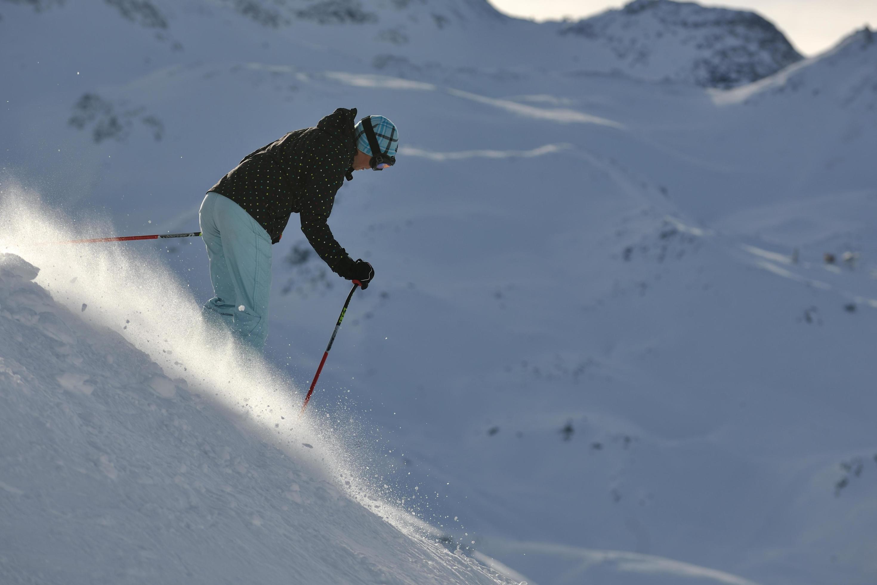 woman skiing on fresh snow at winter season Stock Free