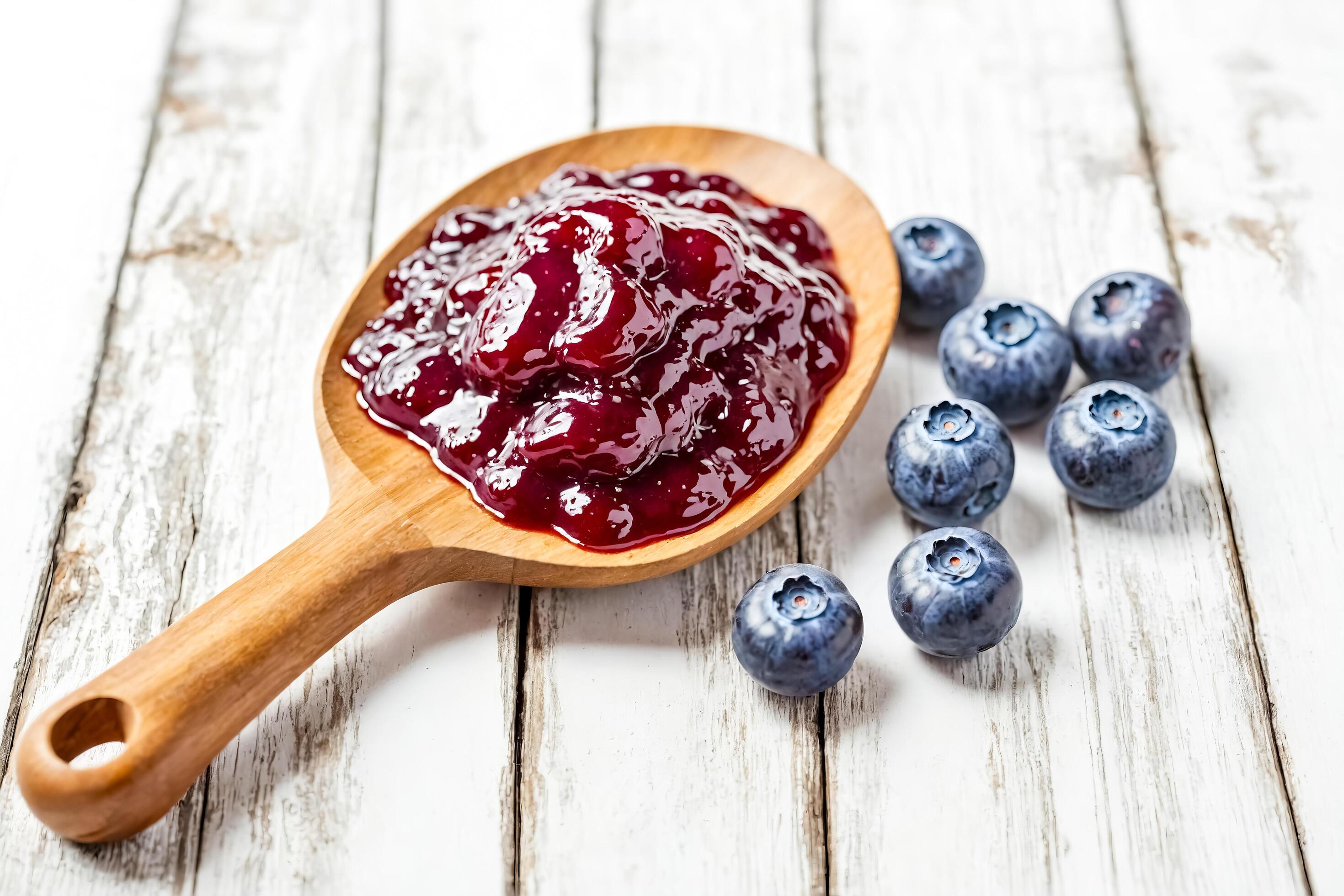 Blueberry jam and blueberries on a white wooden background Stock Free