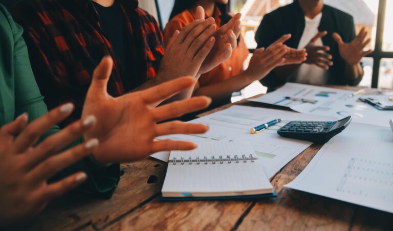 cheerful-business-colleagues-applauding-in-meeting-at-coworking-office-free-photo