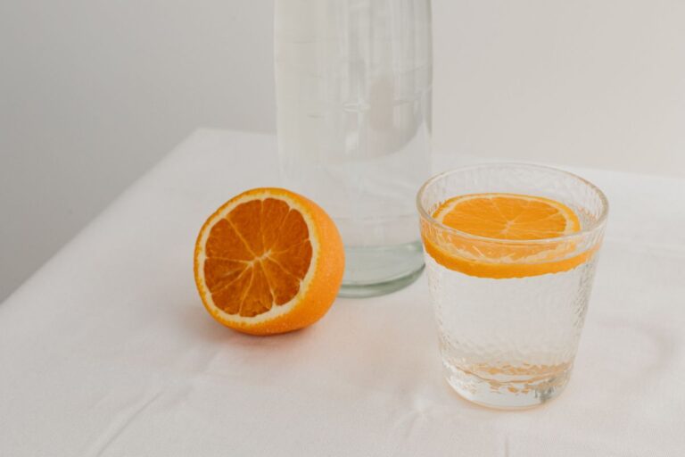 Fresh juicy oranges - a glass and a bottle of water Stock Free