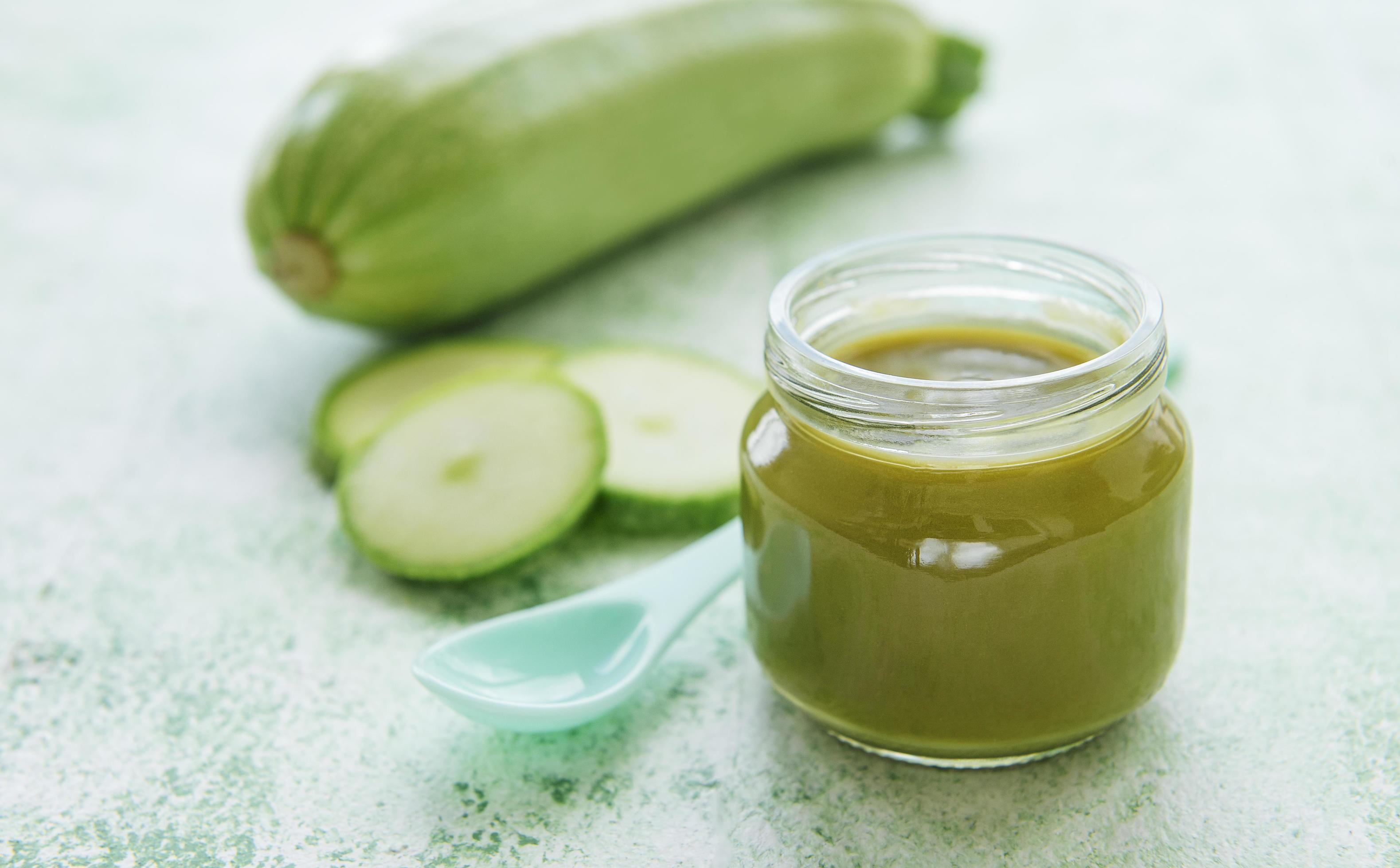 Jar with healthy baby food and zucchini Stock Free