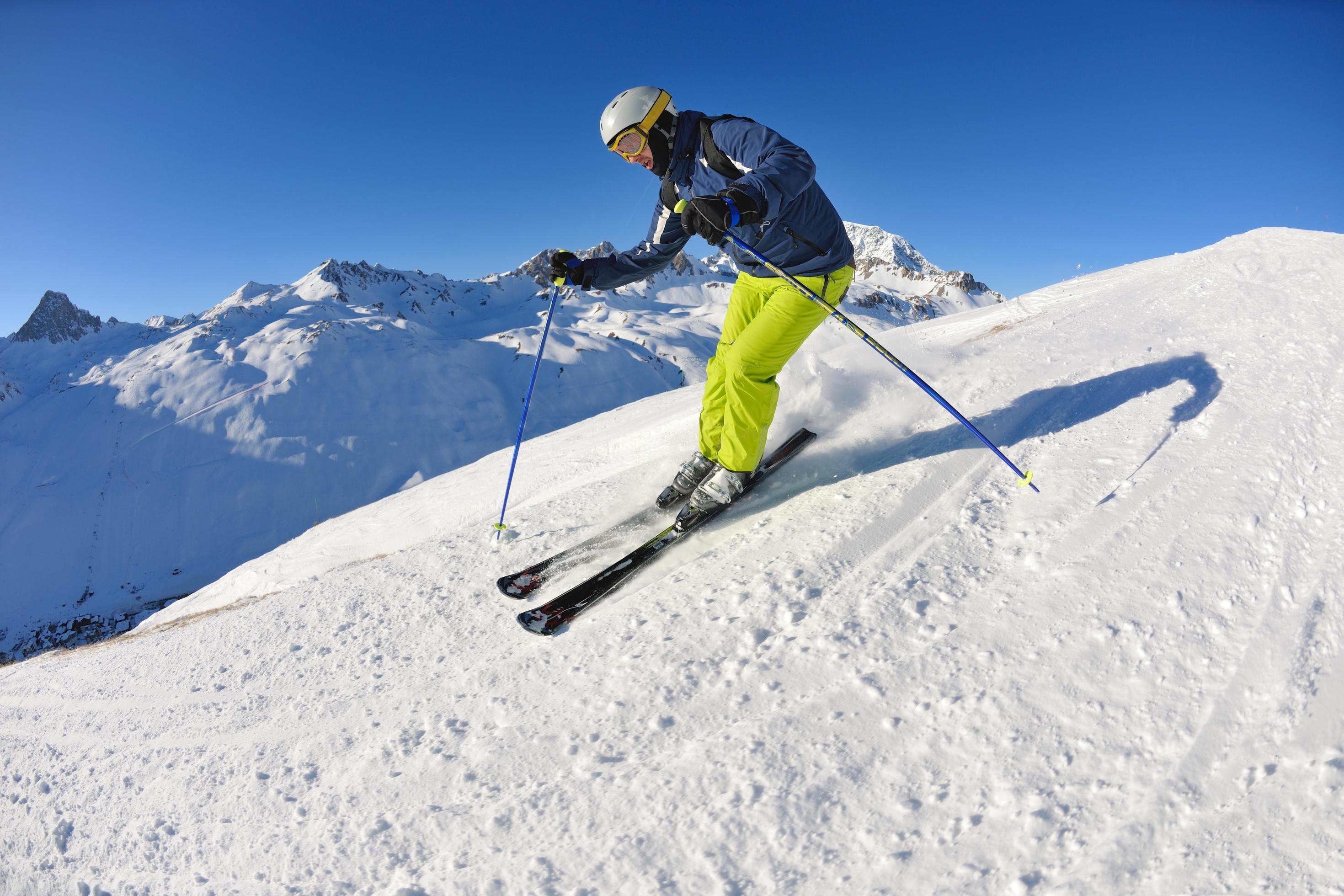 skiing on fresh snow at winter season at beautiful sunny day Stock Free