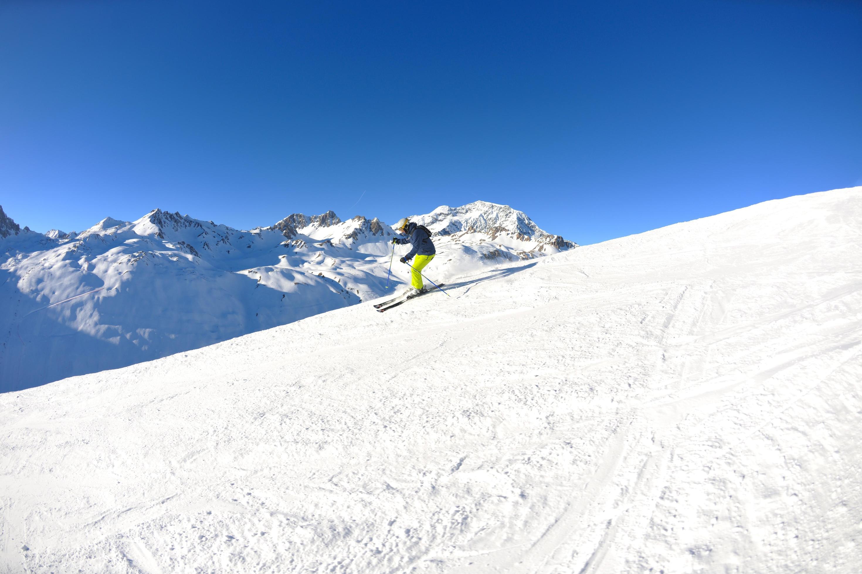 skiing on fresh snow at winter season at beautiful sunny day Stock Free