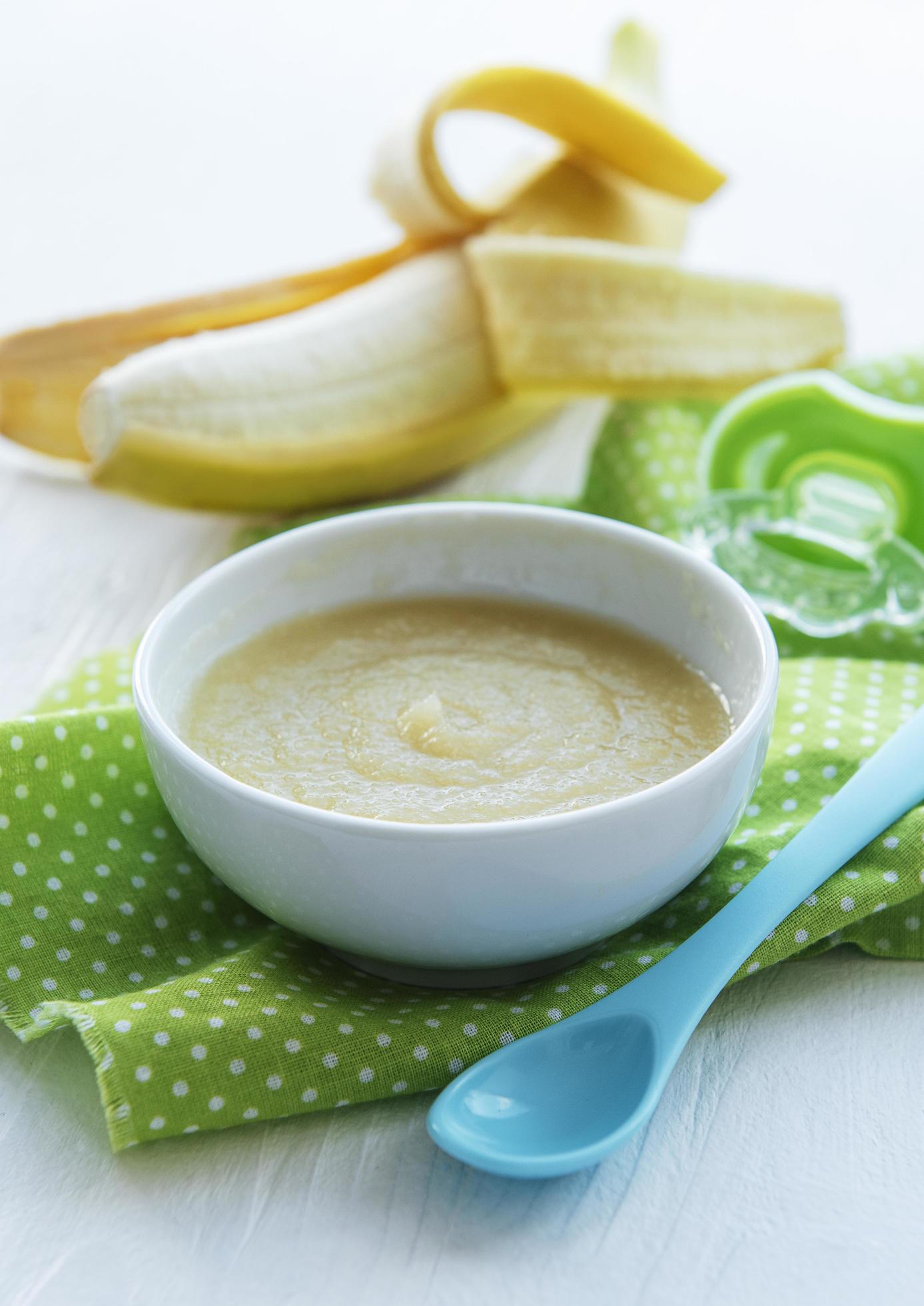 Bowl with fruit baby food and banana Stock Free