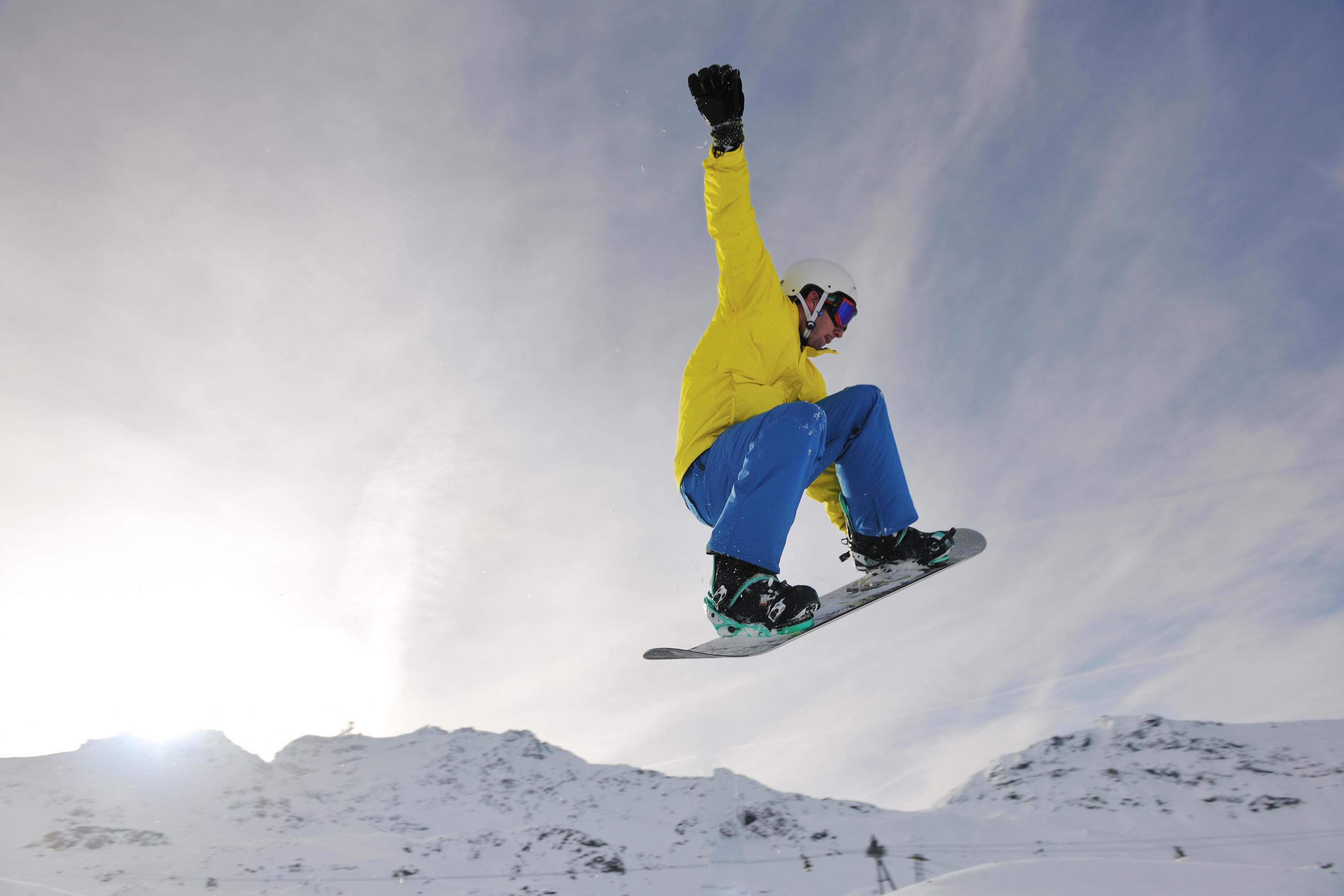 happy young man have fun at winter on mountain peak Stock Free