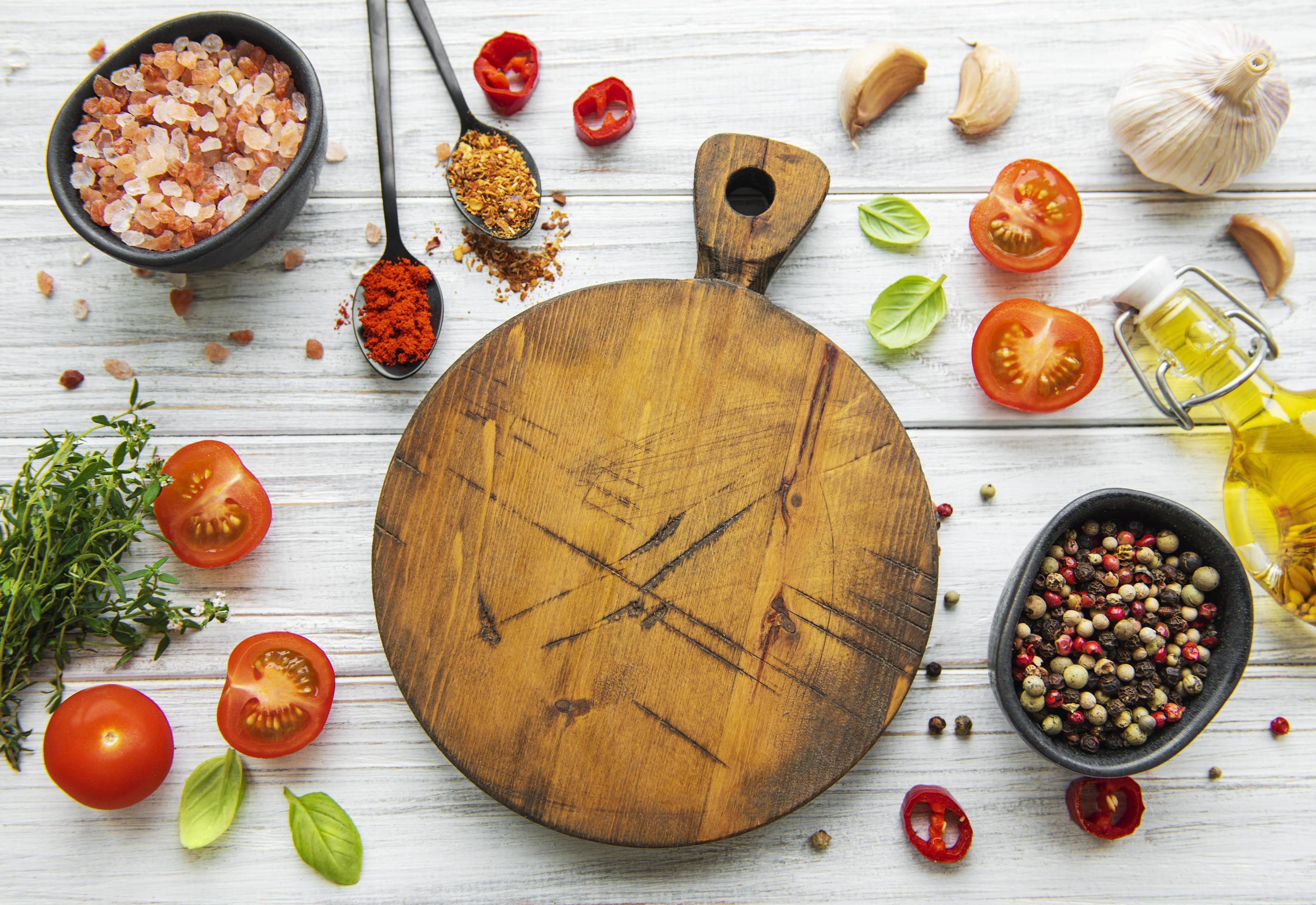 Cooking wooden utensils, empty cutting board and spices. Food cooking template concept. Top view with copy space. Flat lay Stock Free