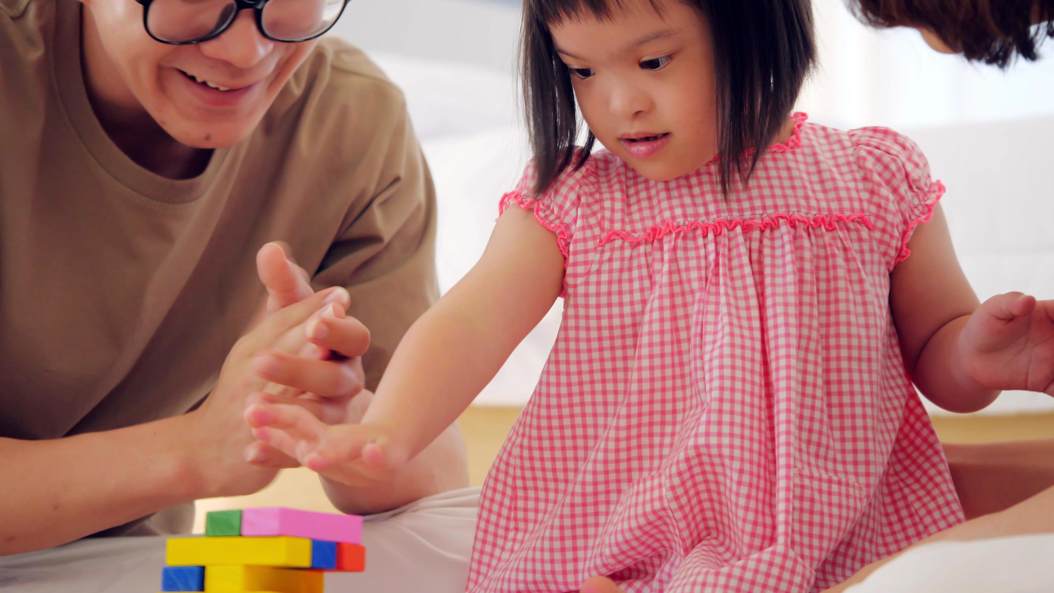 Happy family with mother, father and disabled daughter spending time together at home. Stock Free