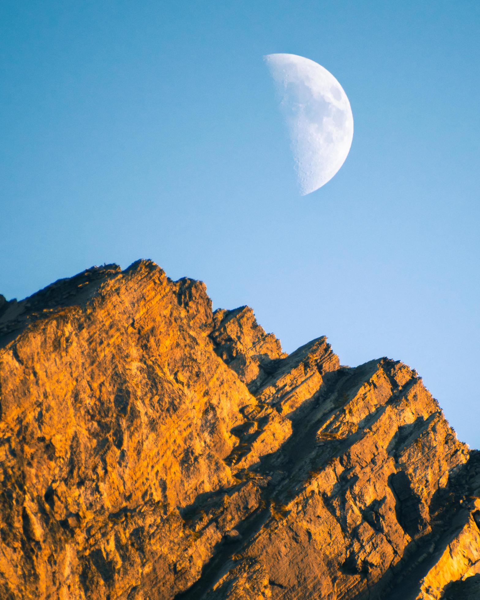 Moon transition across the sky with blue clear sky to cloud cover. Changing weather conditions watching moon Stock Free