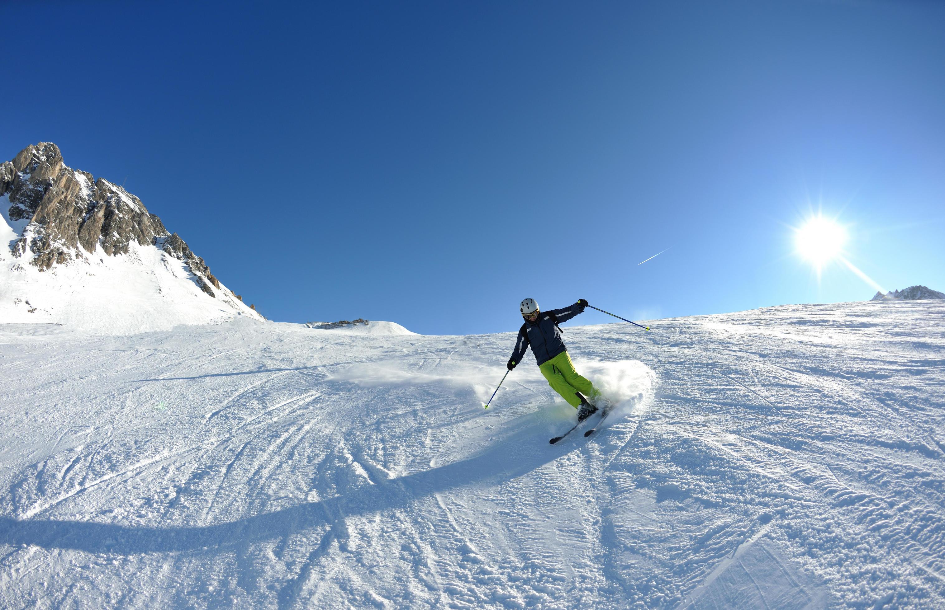 skiing on fresh snow at winter season at beautiful sunny day Stock Free